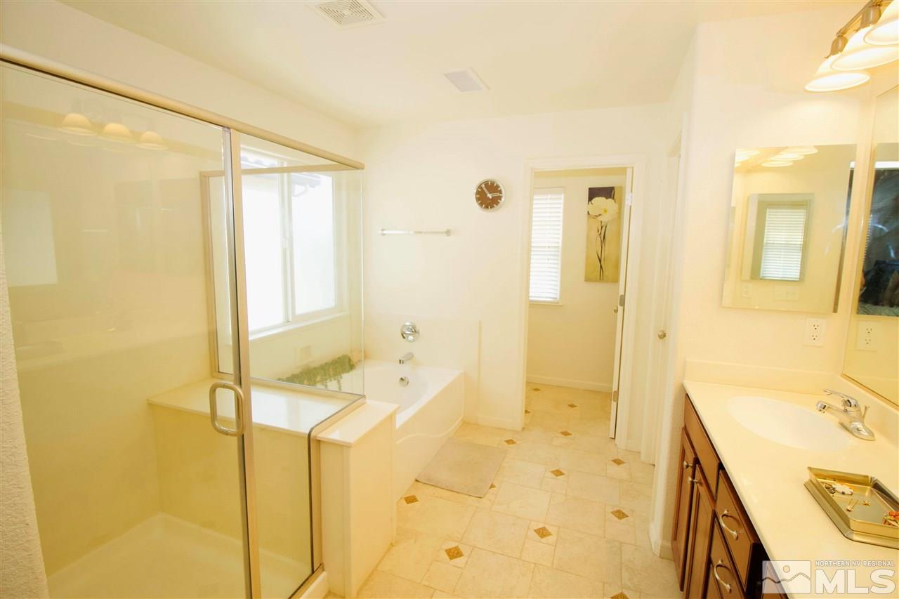 505 Terracina Way Reno, NV 89521 - Photo 17 of 26 a bathroom with a bathtub sink and mirror