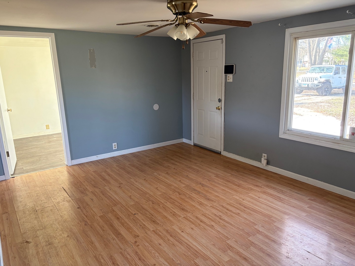 3543 William Street Steger, IL 60475 - Photo 5 of 21 a view of an empty room with wooden floor and a window