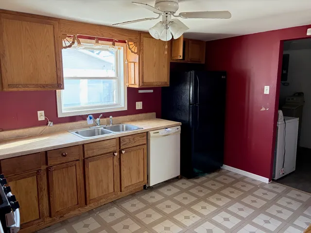 a kitchen with a sink cabinets and appliances