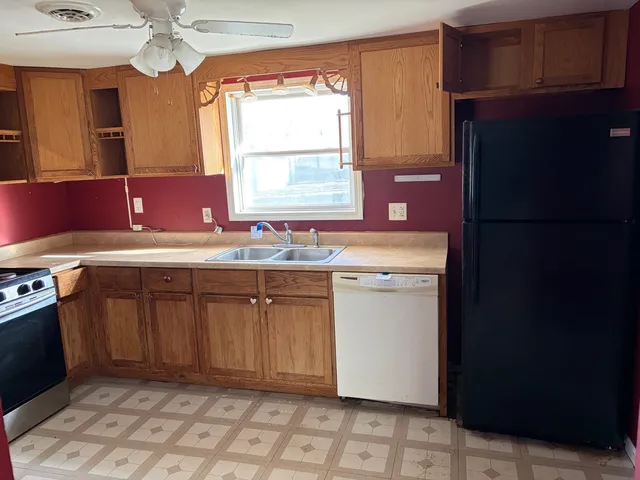 a utility room with a sink cabinets and a window