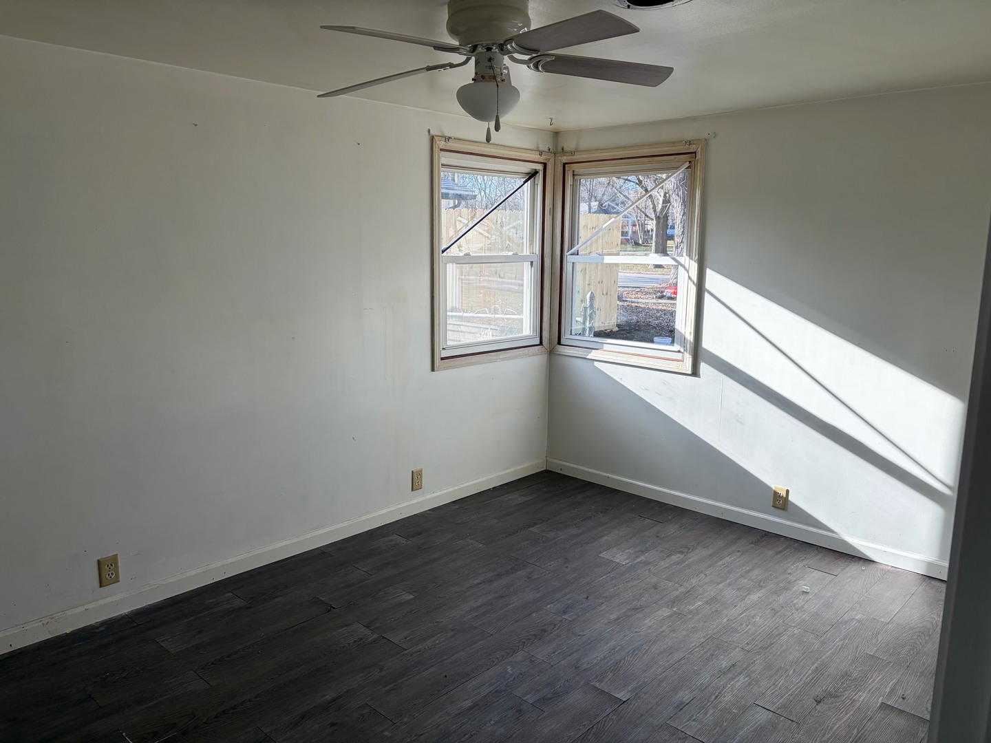 3543 William Street Steger, IL 60475 - Photo 9 of 21 an empty room with wooden floor fan and windows