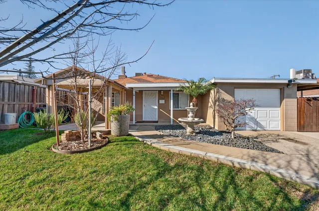 a view of a street with a small garden