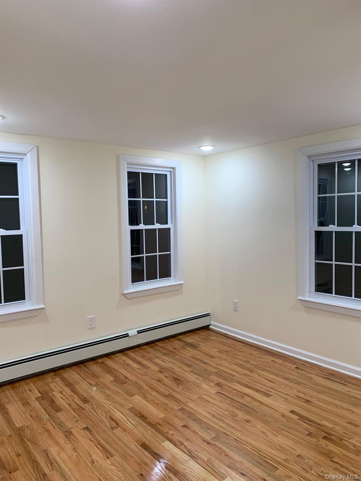 39 Ann Street Ossining, NY 10562 - Photo 14 of 27 an empty room with wooden floor and windows