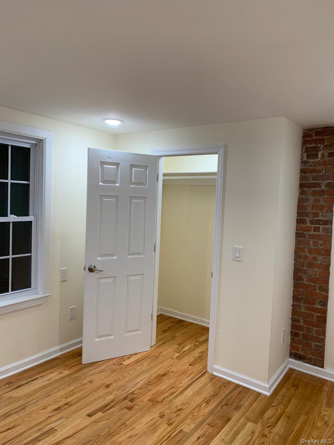 39 Ann Street Ossining, NY 10562 - Photo 18 of 27 an empty room with wooden floor and windows