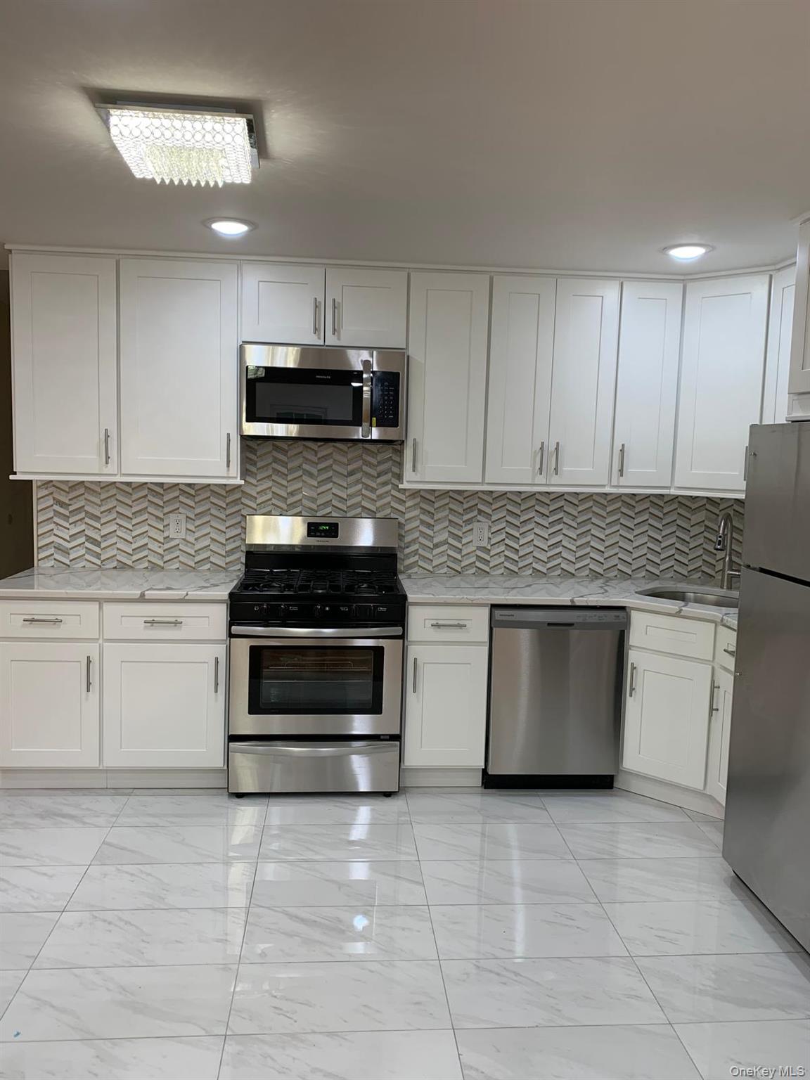 39 Ann Street Ossining, NY 10562 - Photo 4 of 27 a kitchen with granite countertop a stove top oven microwave and cabinets
