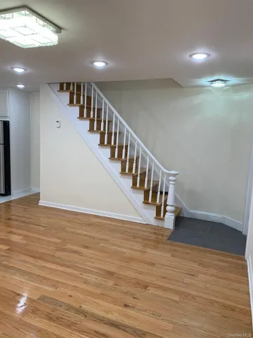 a view of entryway and hall with wooden floor