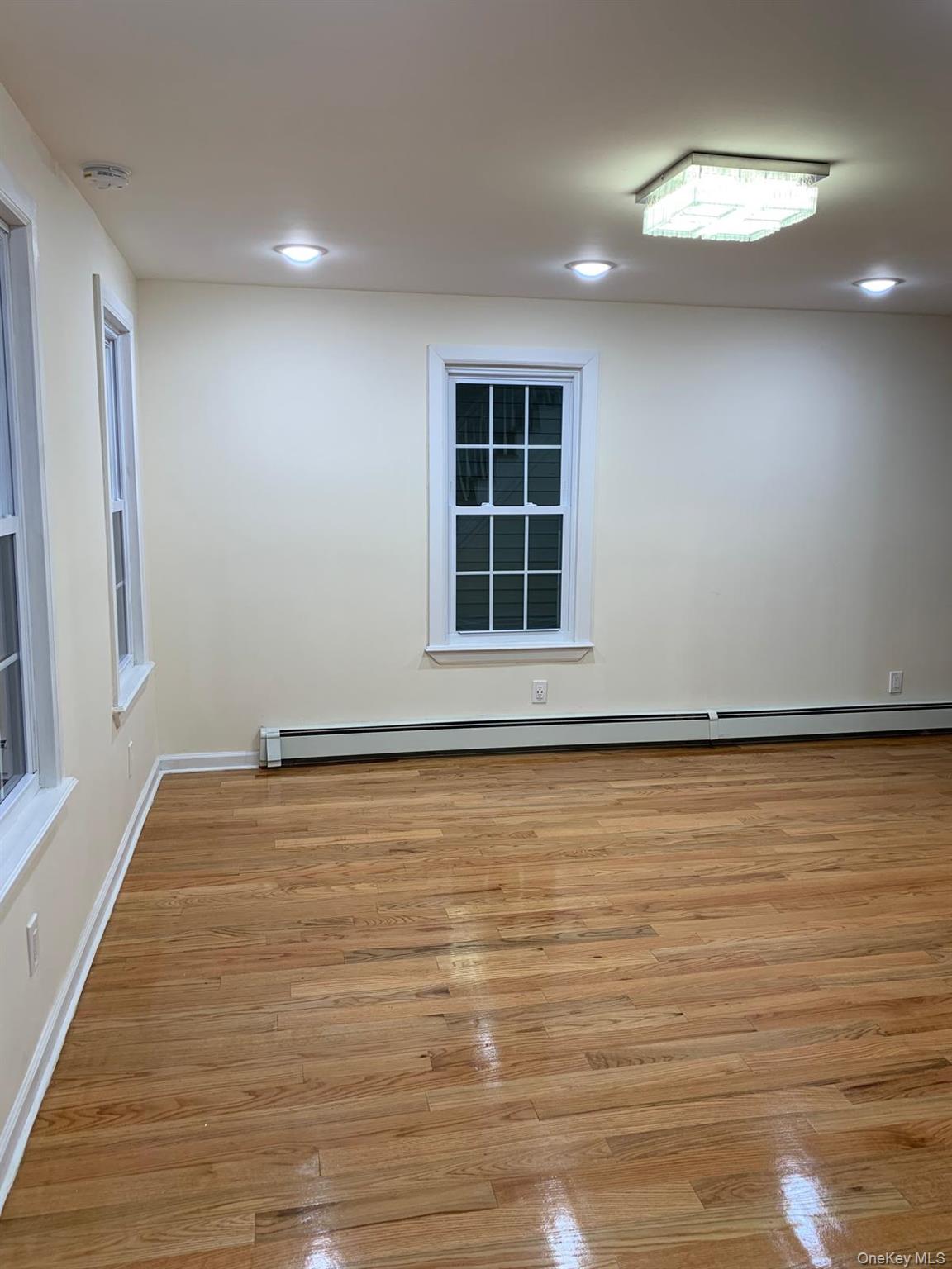 39 Ann Street Ossining, NY 10562 - Photo 9 of 27 a view of an empty room with wooden floor and a window