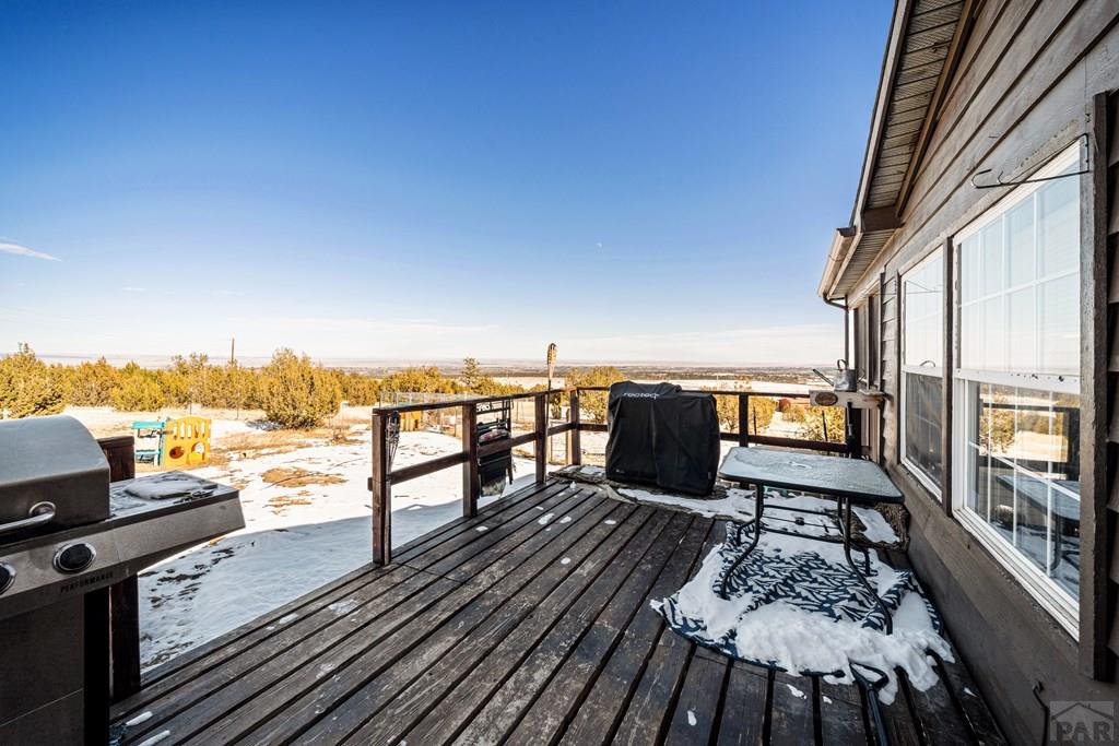 8435 Savage Road Beulah, CO 81023 - Photo 26 of 34 a view of balcony with wooden floor and outdoor seating