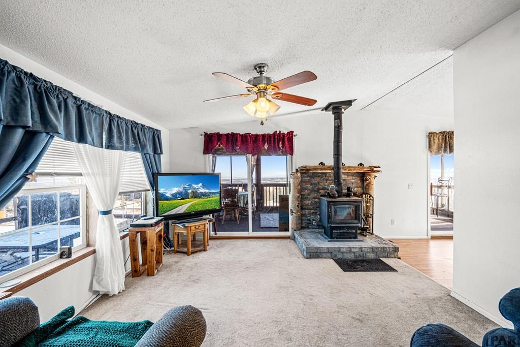8435 Savage Road Beulah, CO 81023 - Photo 10 of 34 a living room with furniture a flat screen tv and kitchen view