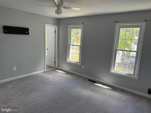 an empty room with windows and closet