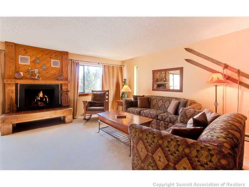 350 4 O Clock Road, Unit D Breckenridge, CO 80424 - Photo 1 of 5 a living room with furniture a fireplace and a flat screen tv