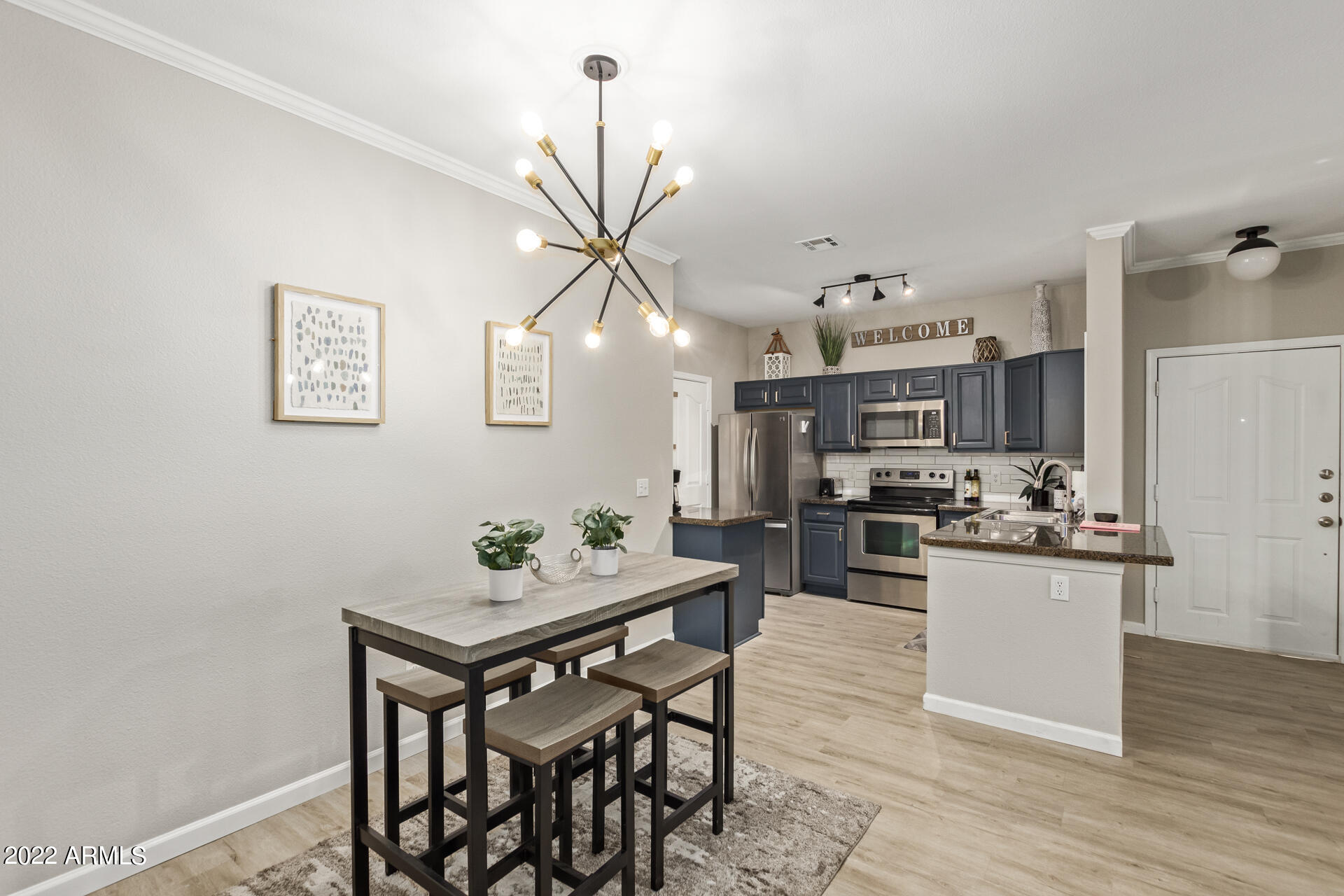16013 South Desert Foothills Parkway, Unit 1033 Phoenix, AZ 85048 - Photo 12 of 42 a kitchen with a table and chairs in it