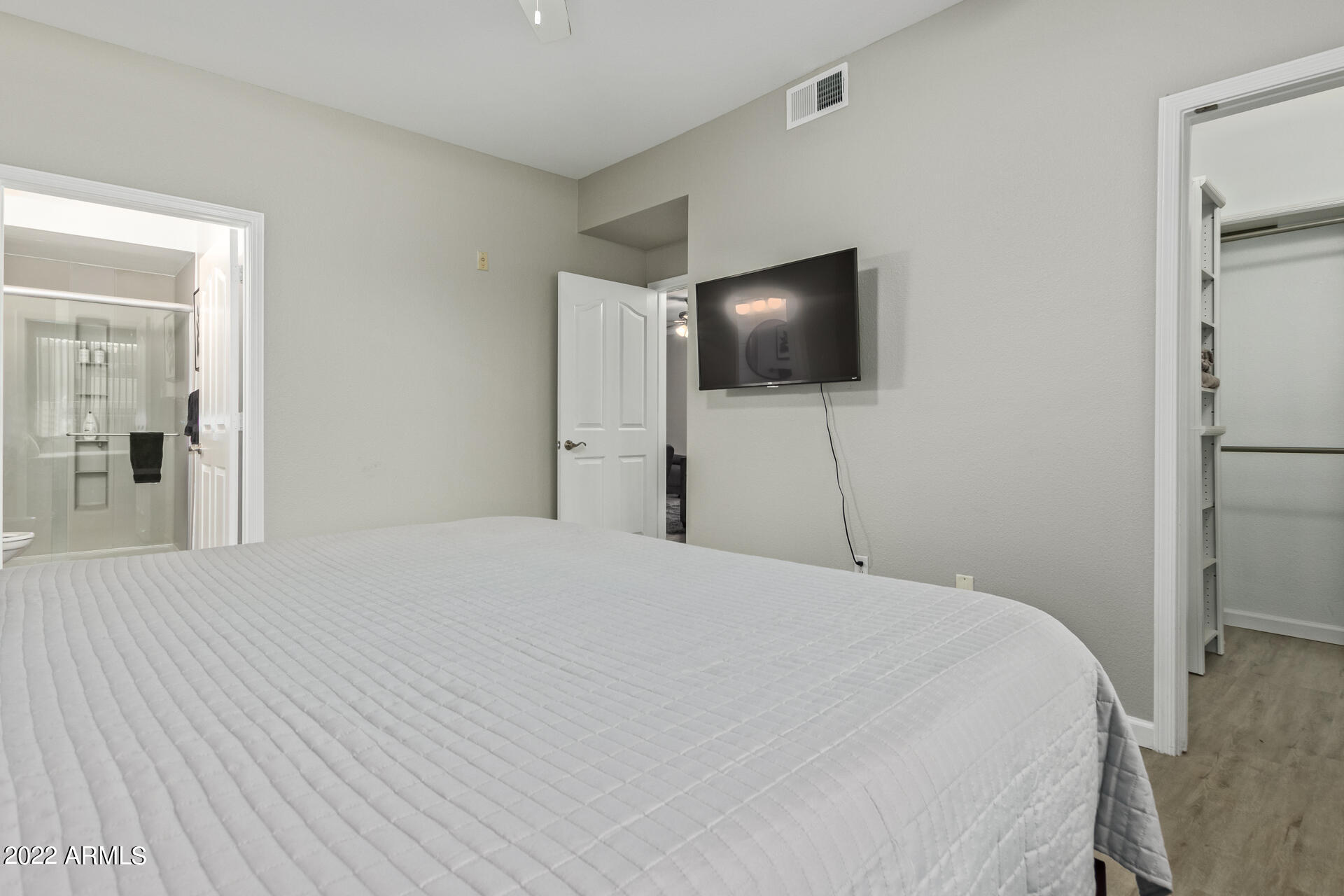 16013 South Desert Foothills Parkway, Unit 1033 Phoenix, AZ 85048 - Photo 17 of 42 a bedroom with a bed and a flat screen tv