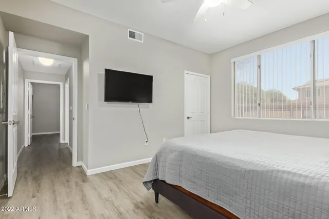 a bedroom with a bed and a flat screen tv