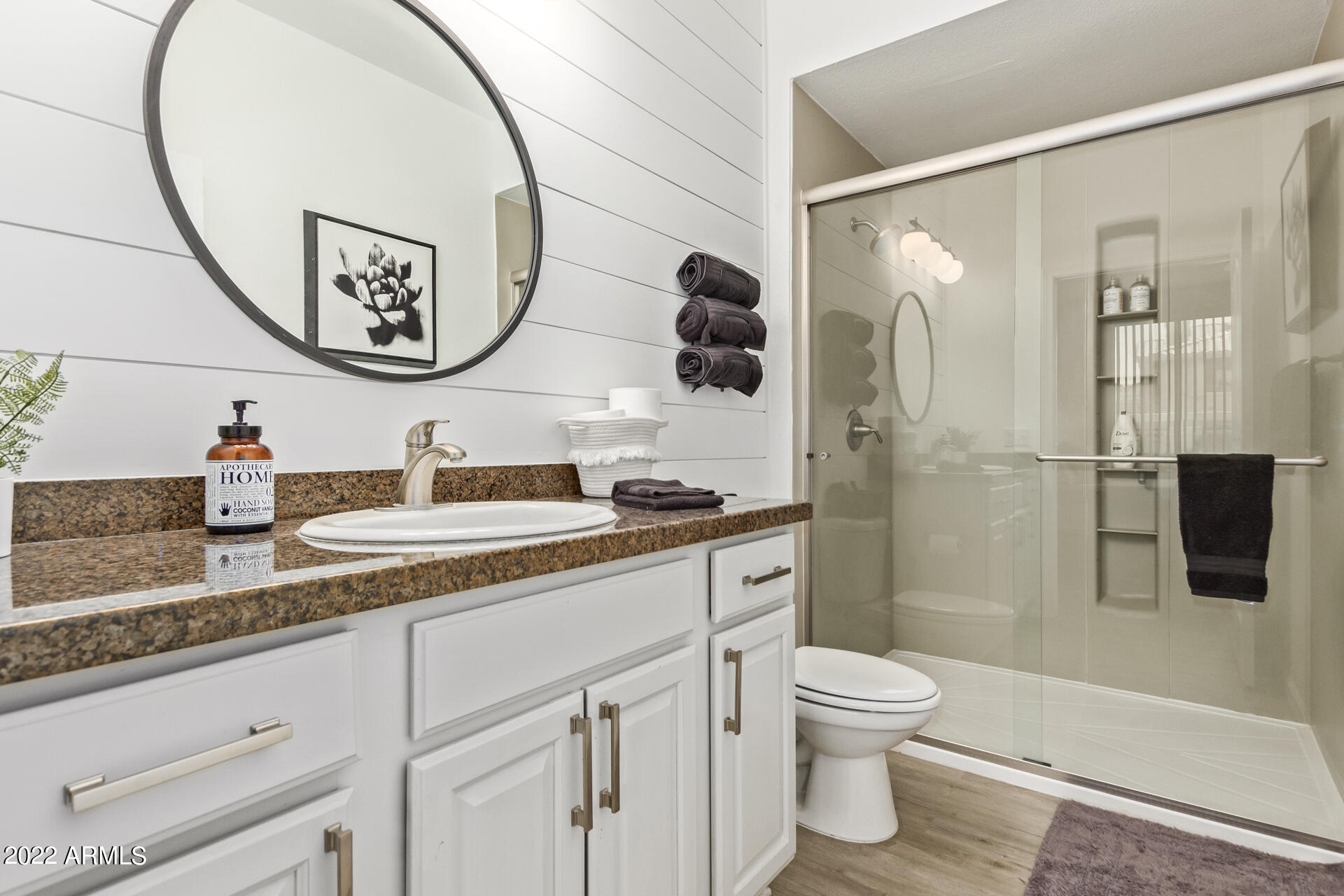 16013 South Desert Foothills Parkway, Unit 1033 Phoenix, AZ 85048 - Photo 20 of 42 a bathroom with a granite countertop sink a toilet and a mirror