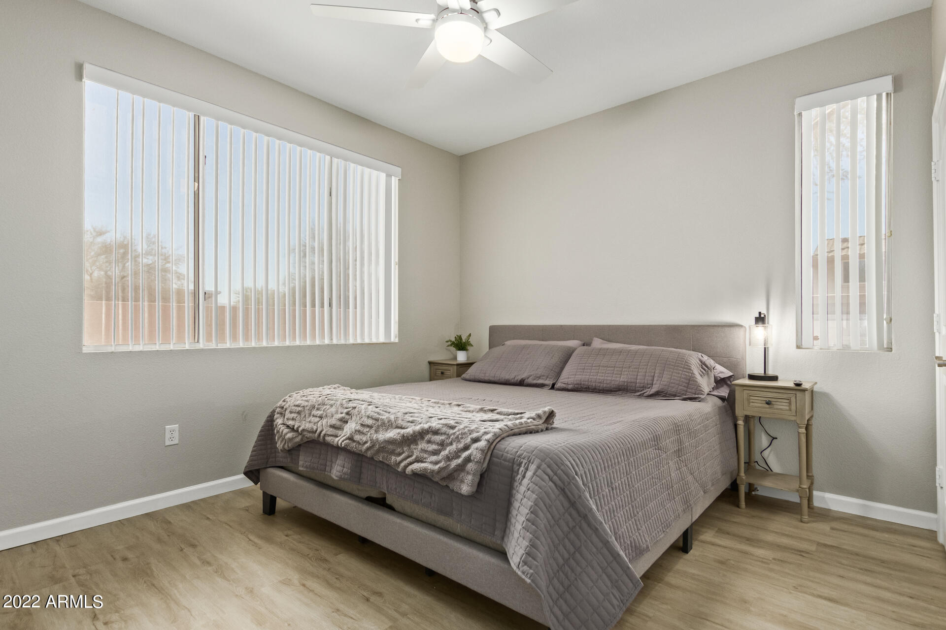 16013 South Desert Foothills Parkway, Unit 1033 Phoenix, AZ 85048 - Photo 21 of 42 a bedroom with a bed and a chandelier