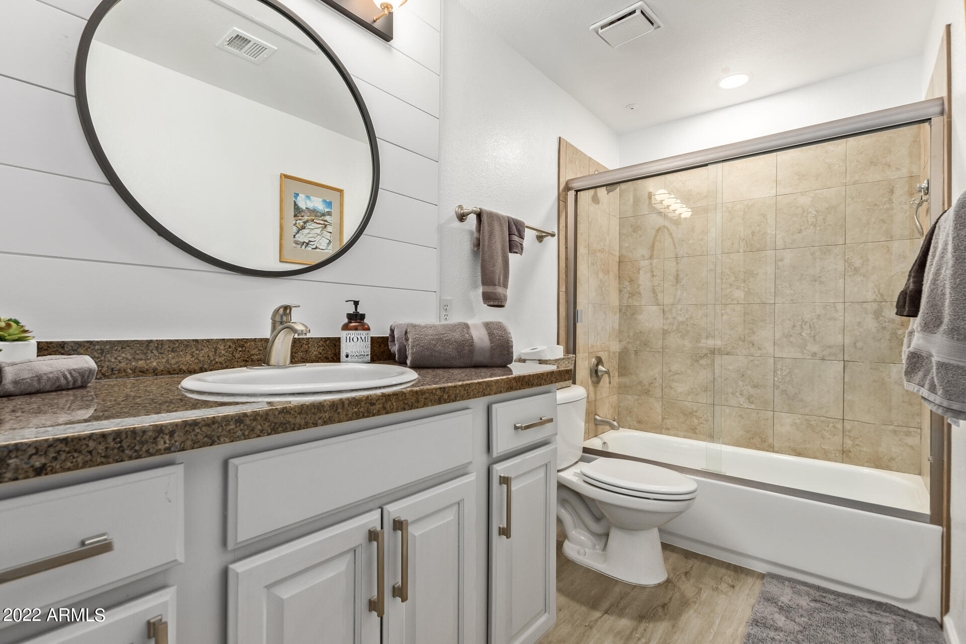 16013 South Desert Foothills Parkway, Unit 1033 Phoenix, AZ 85048 - Photo 23 of 42 a bathroom with a granite countertop sink toilet mirror and shower