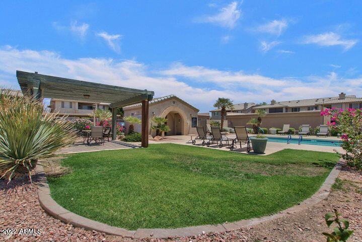 16013 South Desert Foothills Parkway, Unit 1033 Phoenix, AZ 85048 - Photo 31 of 42 a view of a house with a backyard porch and sitting area