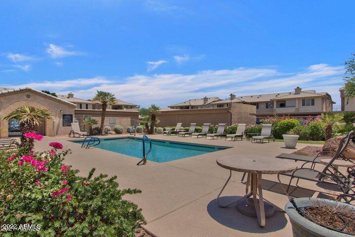 16013 South Desert Foothills Parkway, Unit 1033 Phoenix, AZ 85048 - Photo 32 of 42 a view of a patio with furniture and a potted plant