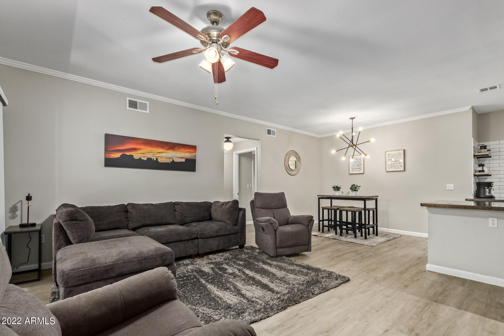 16013 South Desert Foothills Parkway, Unit 1033 Phoenix, AZ 85048 - Photo 7 of 42 a living room with furniture a dining table and paintings on the wall