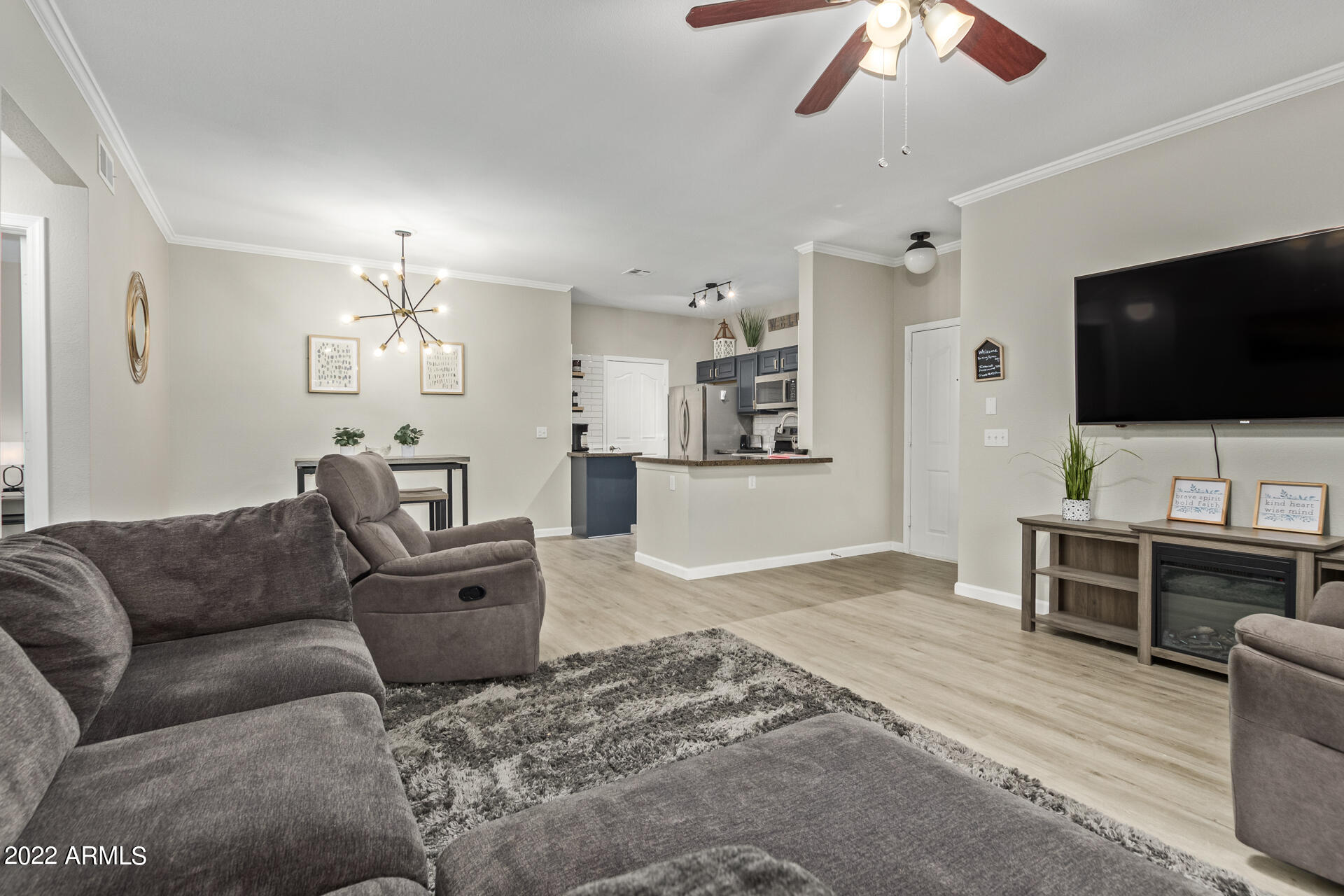 16013 South Desert Foothills Parkway, Unit 1033 Phoenix, AZ 85048 - Photo 8 of 42 a living room with furniture and a flat screen tv