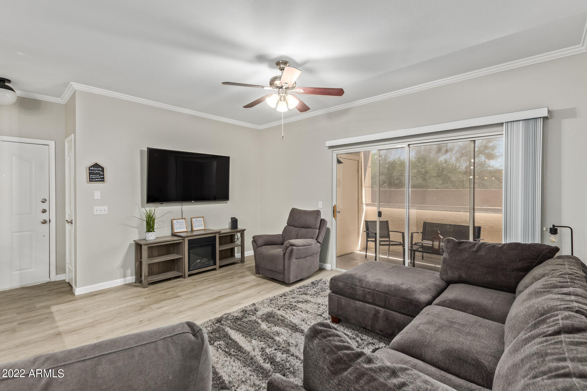 16013 South Desert Foothills Parkway, Unit 1033 Phoenix, AZ 85048 - Photo 10 of 42 a living room with furniture and a flat screen tv