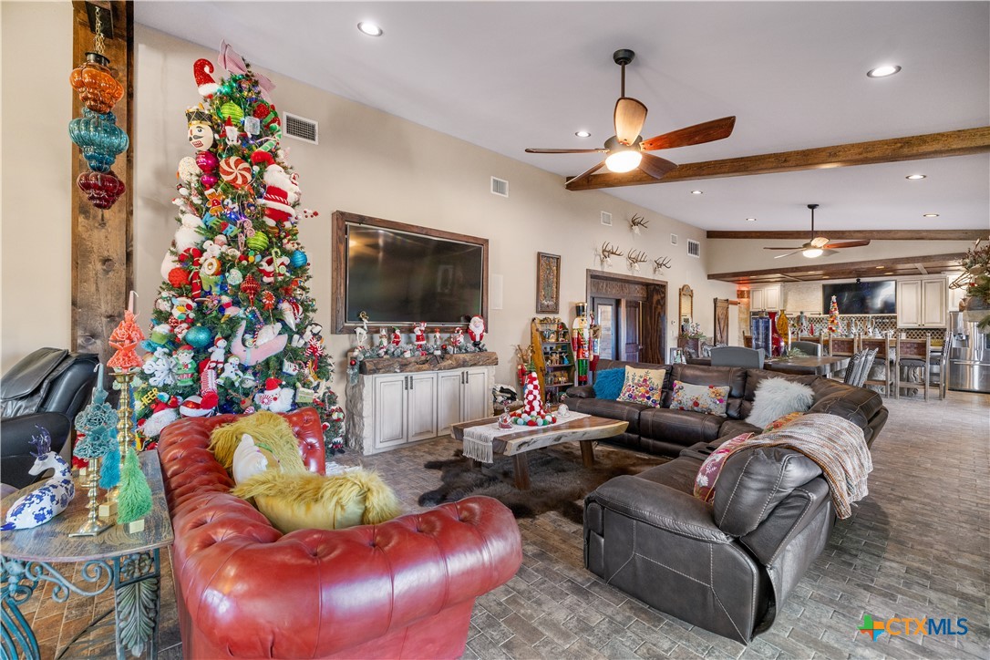 2796 Benbow Road Inez, TX 77968 - Photo 8 of 35 a living room with furniture a flat screen tv and a chandelier