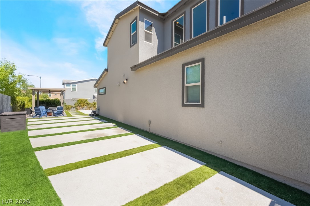 2166 Trivero Street Henderson, NV 89044 - Photo 45 of 61 Sleek contemporary residence showcasing an attractive textured stucco finish and neatly landscaped outdoor areas.