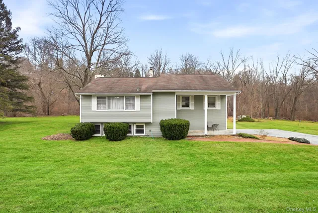 a view of house with backyard