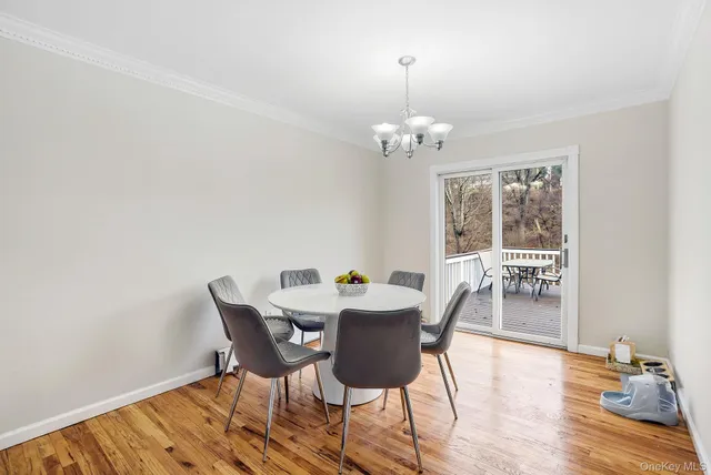 a view of a dining room with furniture wooden floor and chandelier