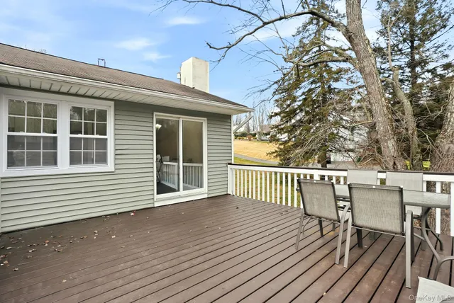a view of a deck with wooden floor and fence