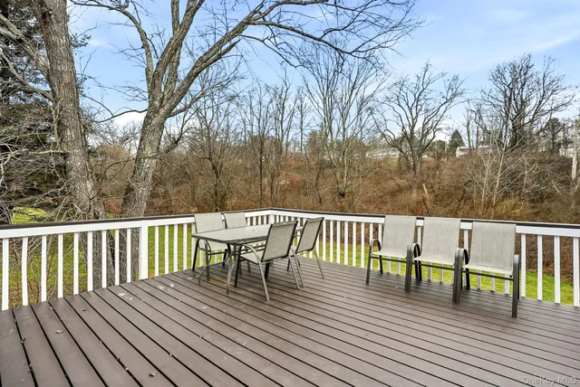 a view of a deck with table and chairs and wooden floor