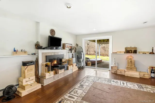 a living room with furniture a fireplace and a flat screen tv