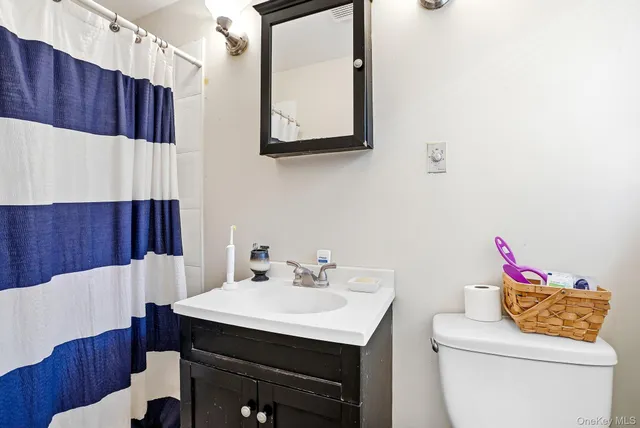 a bathroom with a sink vanity and mirror