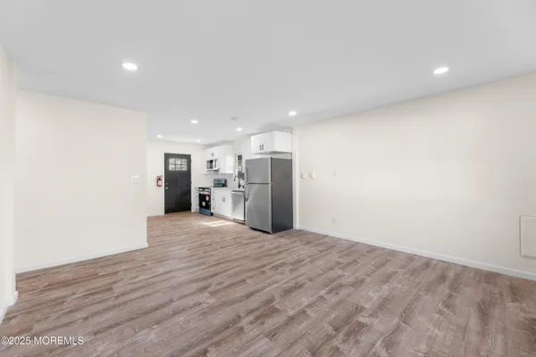 a view of a kitchen with a refrigerator and a microwave