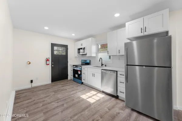 a kitchen with a refrigerator and a sink