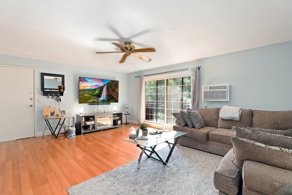 47 West Street, Unit C4 Randolph, MA 02368 - Photo 1 of 19 a living room with furniture and a flat screen tv