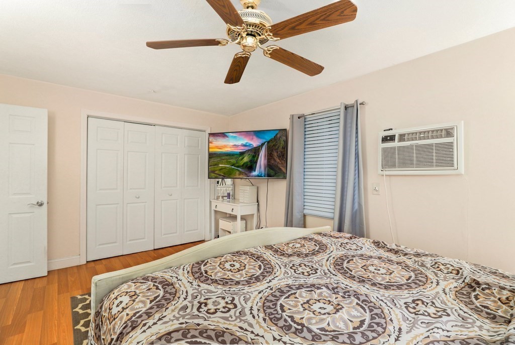 47 West Street, Unit C4 Randolph, MA 02368 - Photo 11 of 19 a bedroom with a bed and a television