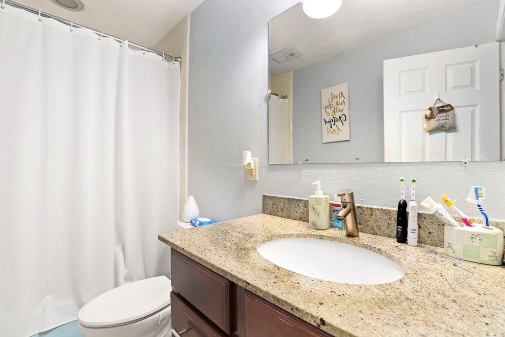 47 West Street, Unit C4 Randolph, MA 02368 - Photo 12 of 19 a bathroom with a granite countertop sink and a mirror