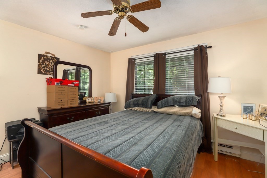 47 West Street, Unit C4 Randolph, MA 02368 - Photo 14 of 19 a bedroom with a bed and wooden floor