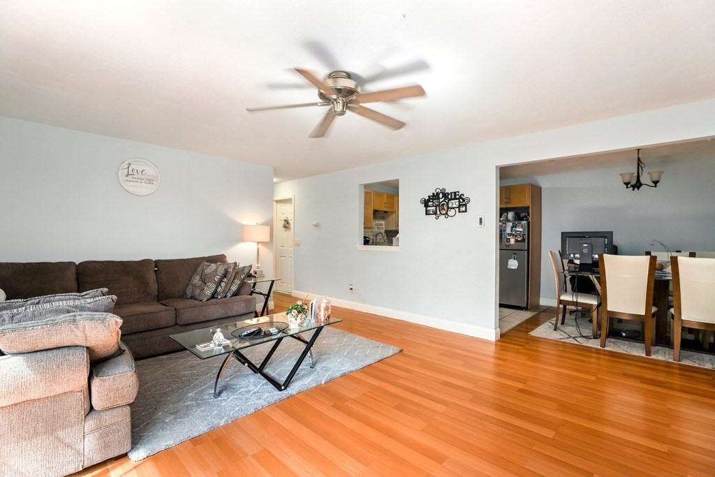 47 West Street, Unit C4 Randolph, MA 02368 - Photo 4 of 19 a living room with furniture and wooden floor