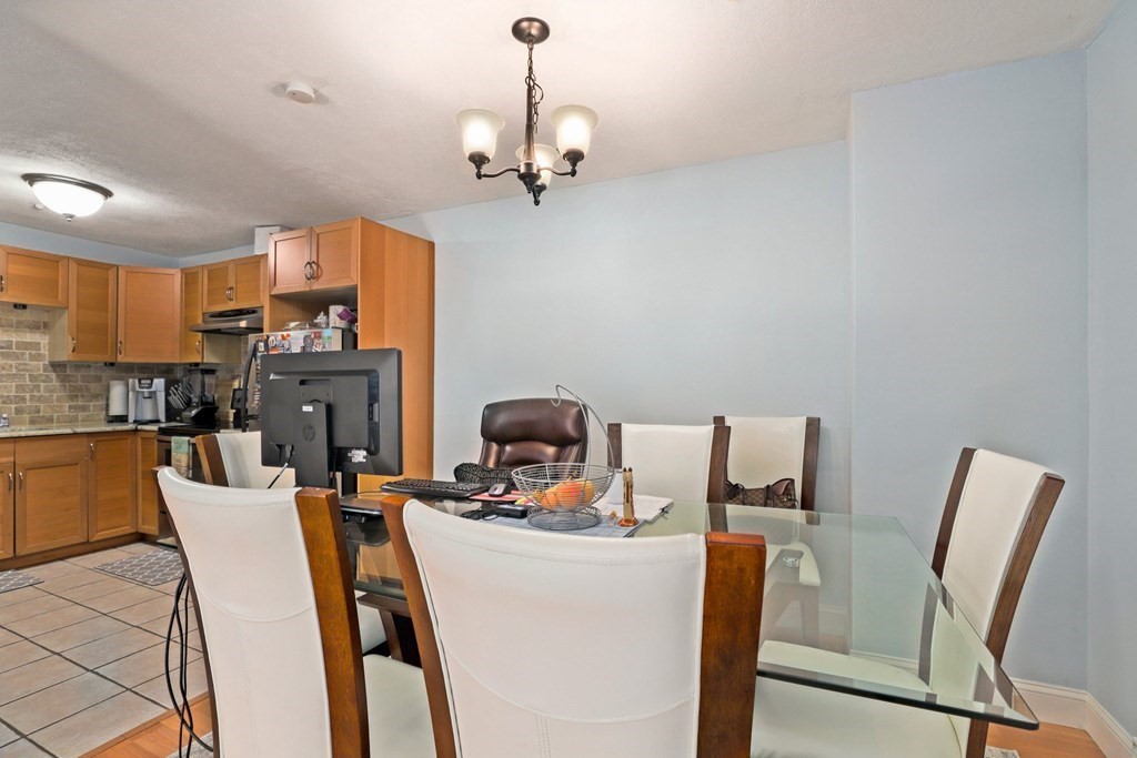 47 West Street, Unit C4 Randolph, MA 02368 - Photo 5 of 19 a view of a dining room with furniture a fireplace and wooden floor