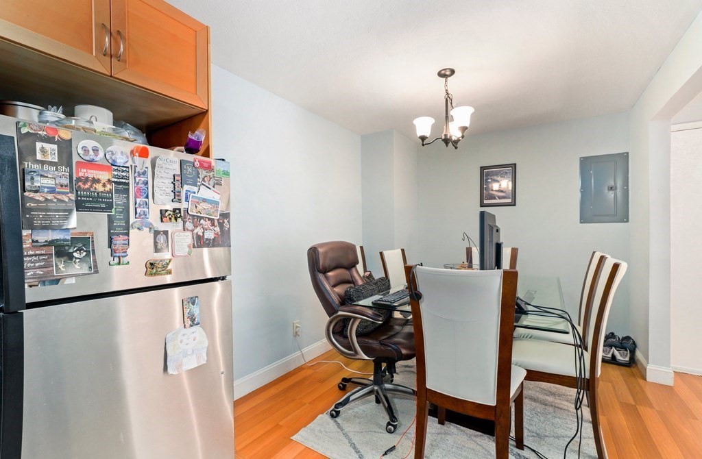 47 West Street, Unit C4 Randolph, MA 02368 - Photo 6 of 19 a view of a dining room with furniture a chandelier and wooden floor