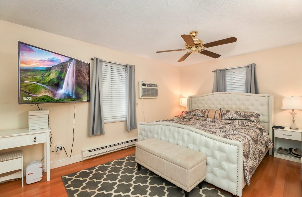 47 West Street, Unit C4 Randolph, MA 02368 - Photo 9 of 19 a bedroom with a bed and a painting on the wall