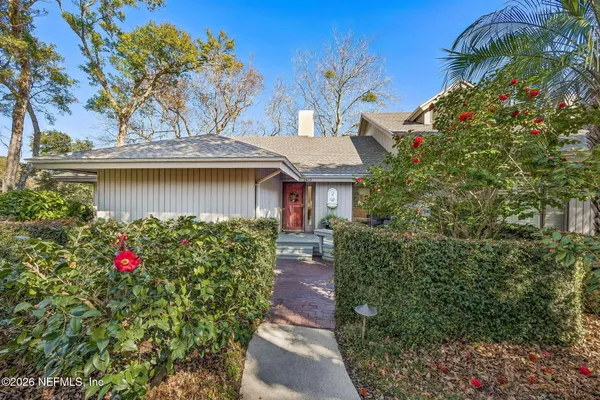 a view of a house with a flower garden