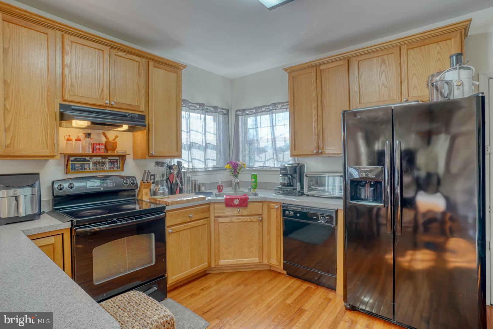 226 York Drive Smyrna, DE 19977 - Photo 11 of 60 a kitchen with stainless steel appliances granite countertop a refrigerator a sink dishwasher a stove and white cabinets with wooden floor