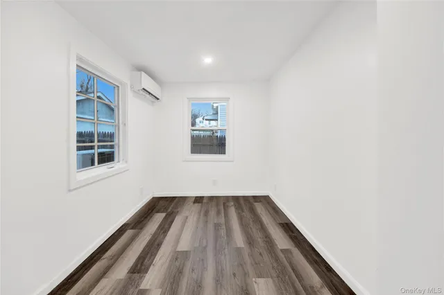 a view of a room with wooden floor and window