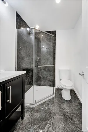 a bathroom with a toilet a sink and a shower
