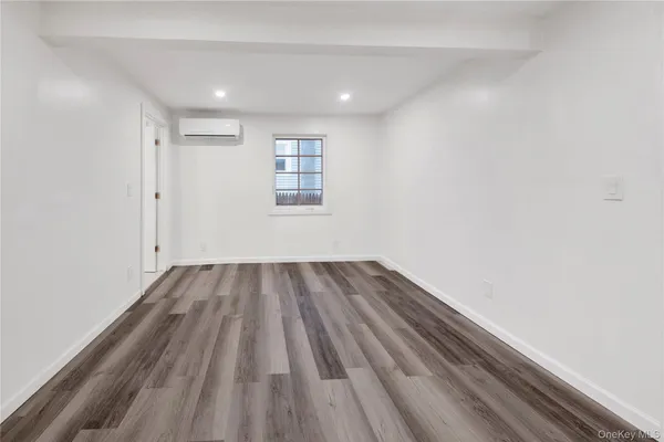 a view of a room with wooden floor and window
