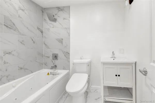 a bathroom with a bathtub toilet and sink